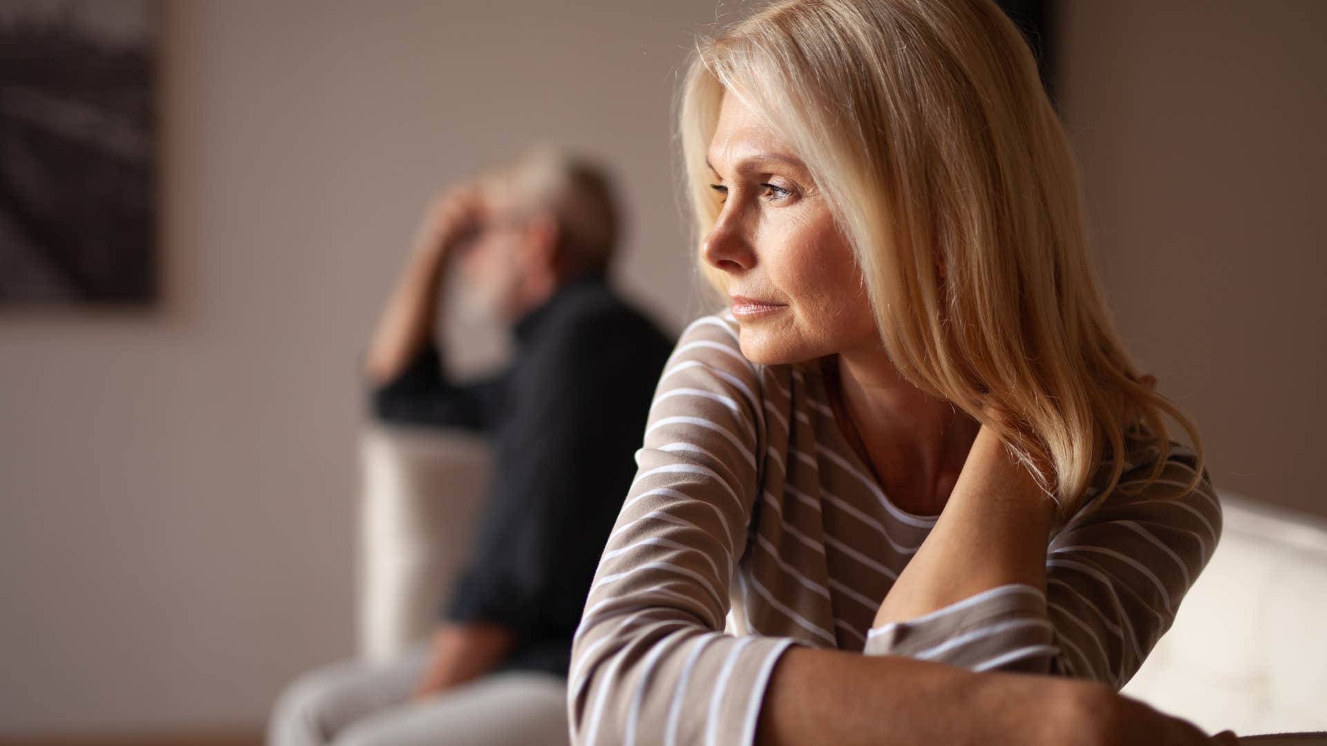 Woman turned away from her husband on the couch. 