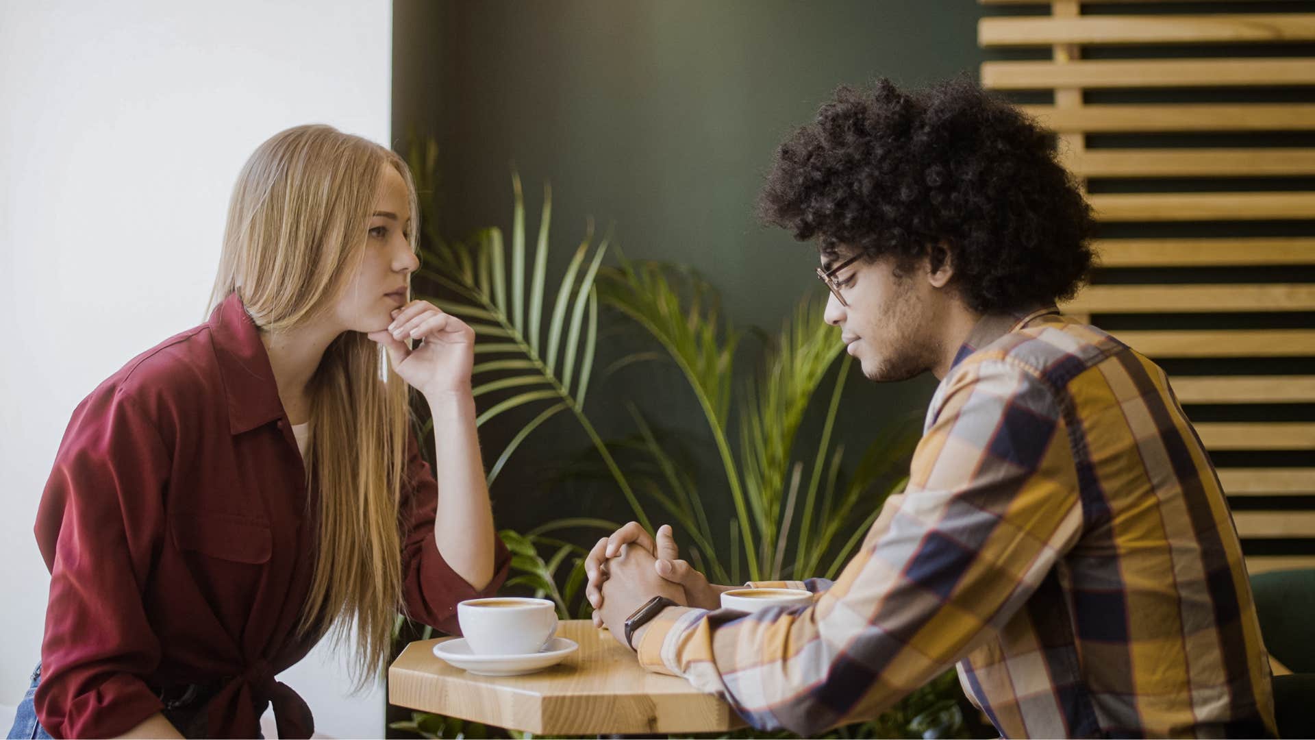 Couple having a serious conversation in a coffee shop.