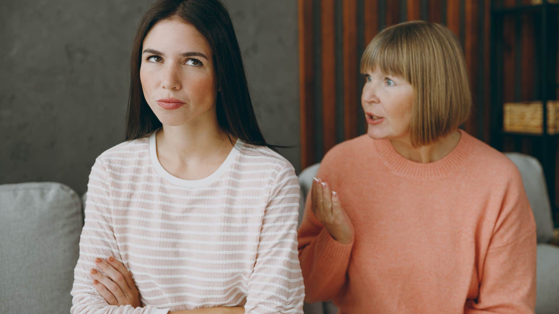 Adult woman looking annoyed while her mom talks to her