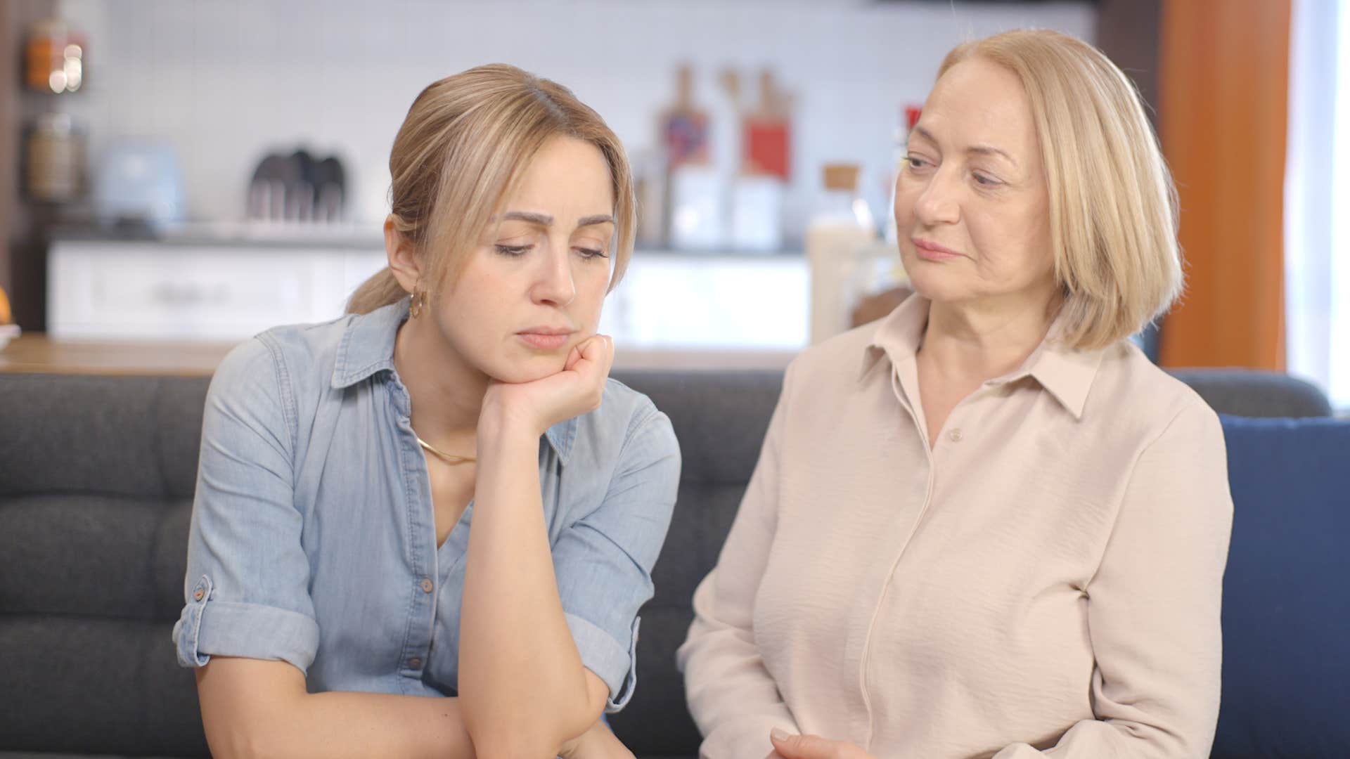 Adult woman looking concerned while her mom looks at her