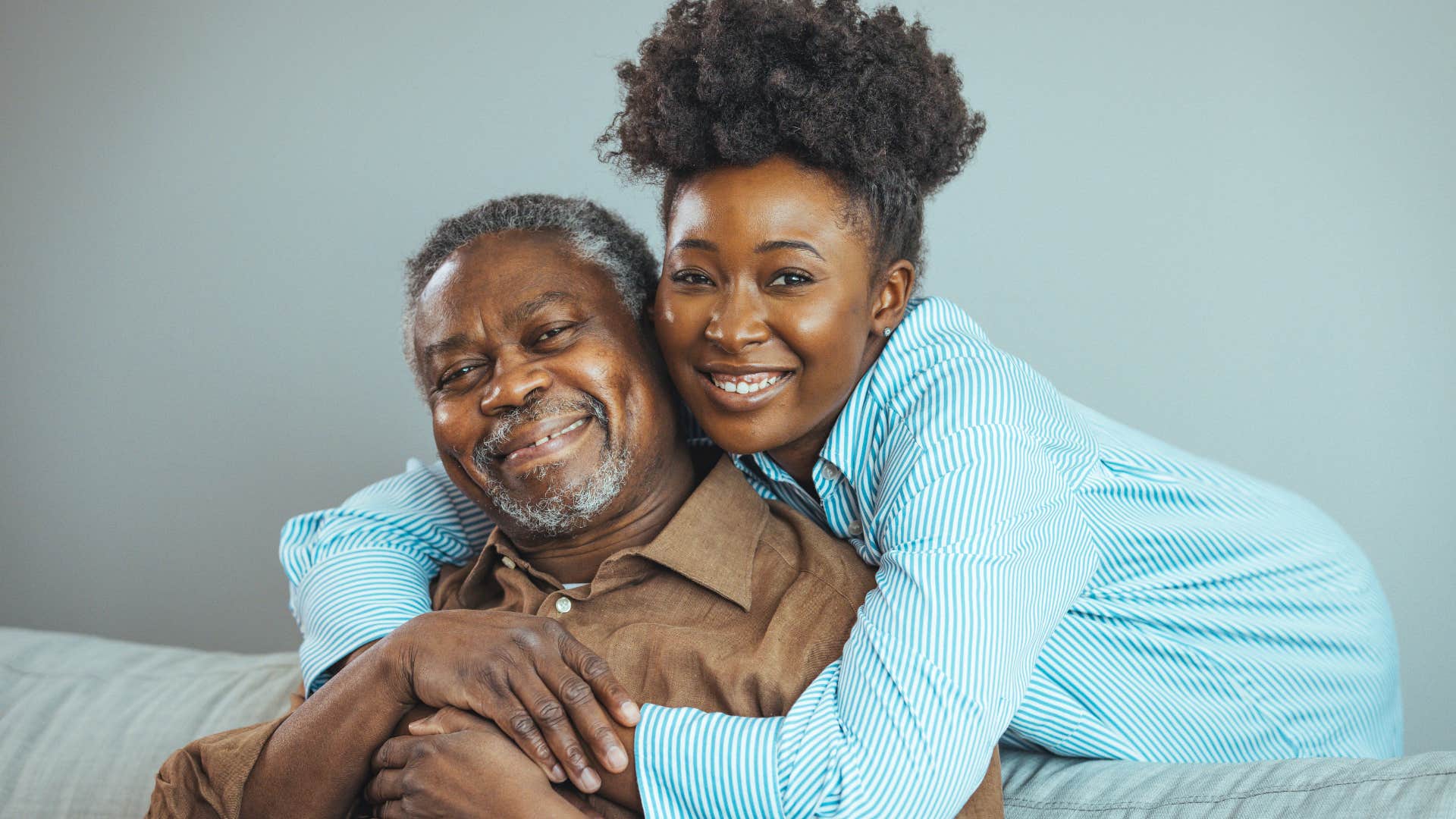 Adult woman hugging her older dad