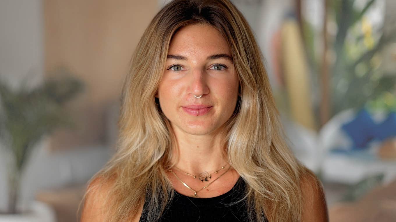 Adult woman smiling at the camera in her home.