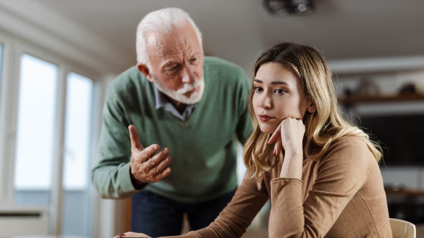 older father lecturing daughter