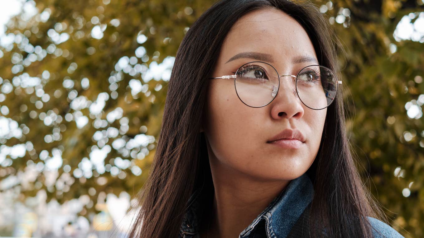 Asian girl wearing glasses and having a photoshoot in the park.