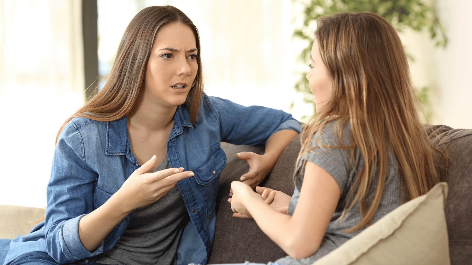 two women having a series conversation on the couch 