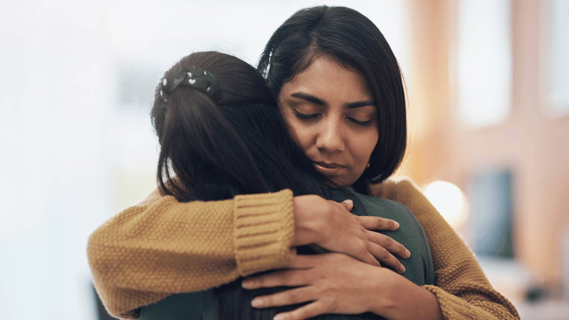 woman hugging friend 