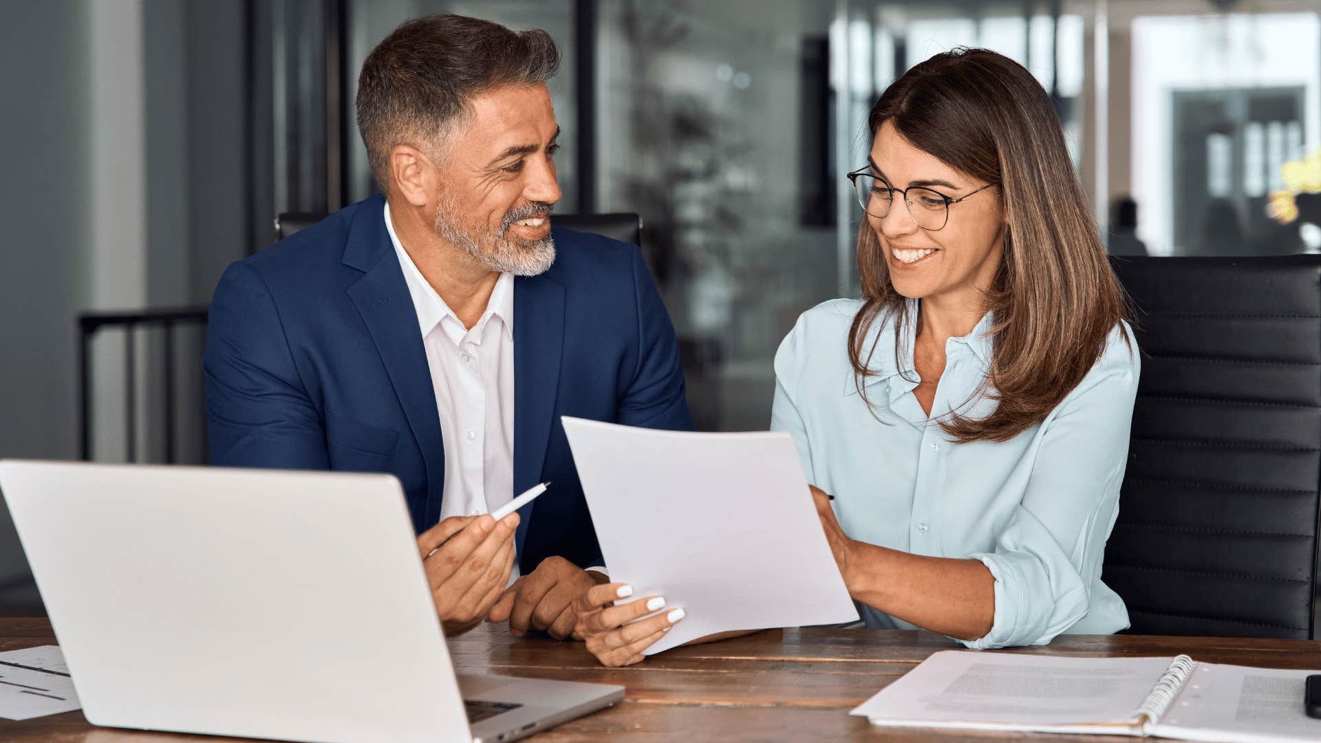 woman and man looking over document 