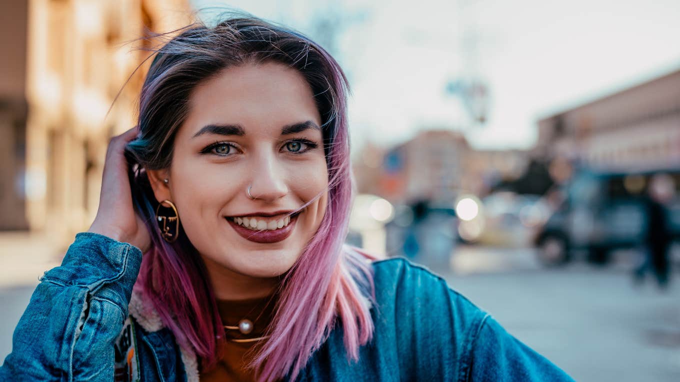 smiling woman with pink hair