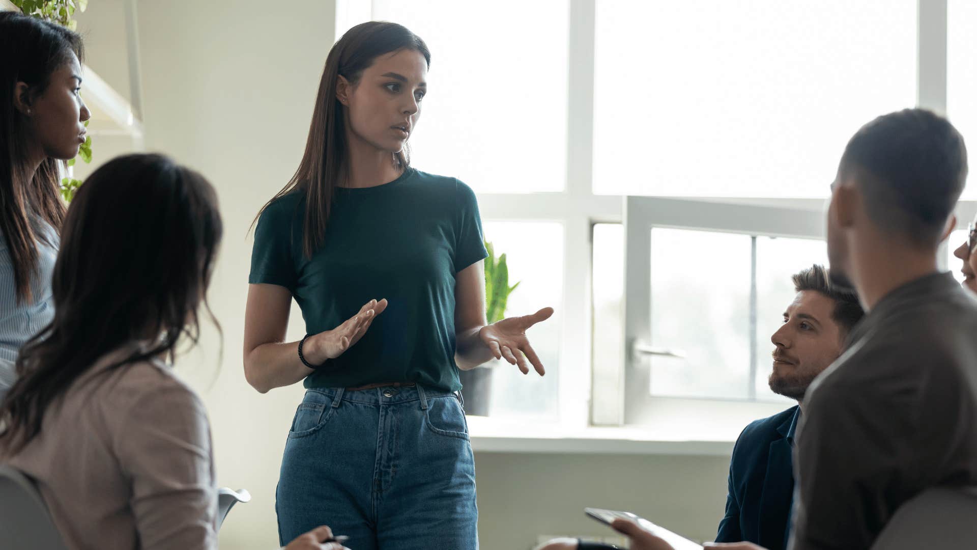 woman explaining something to group of people