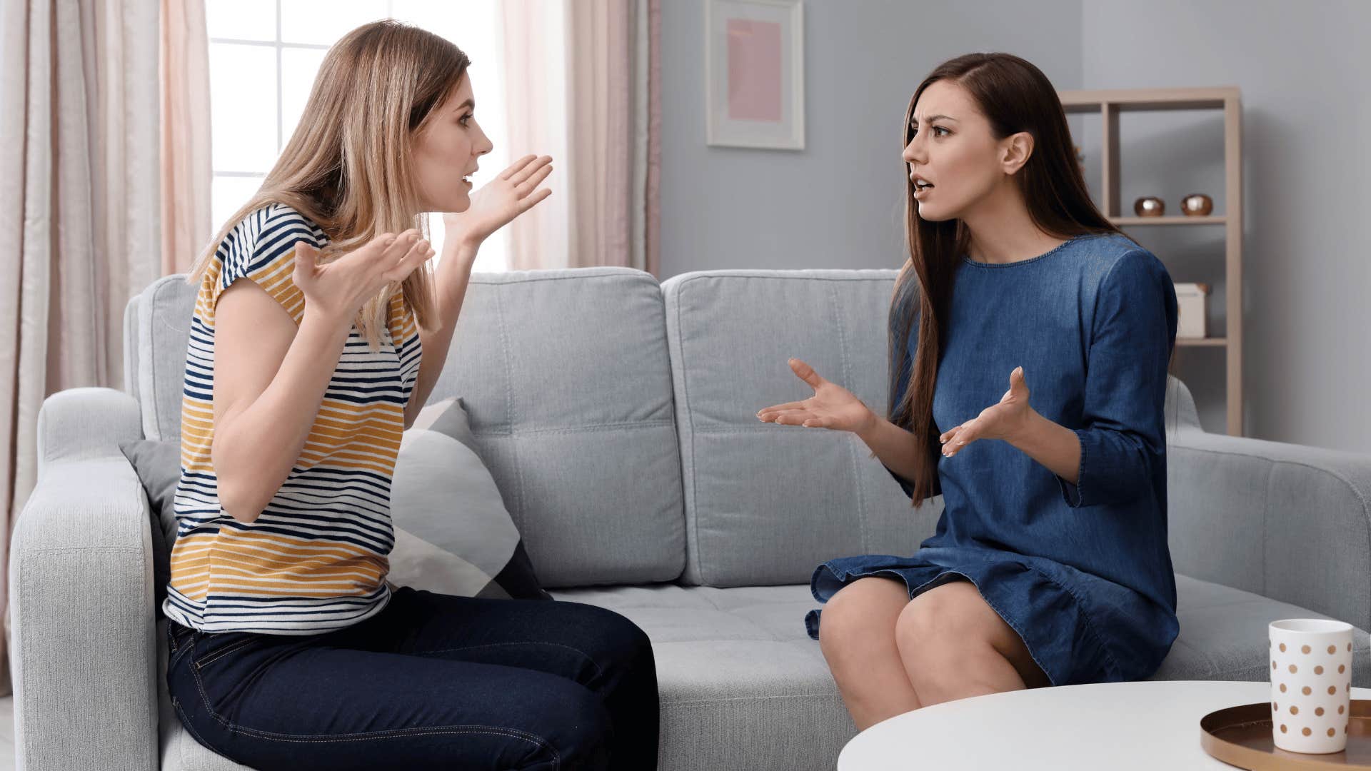 two women arguing on the couch