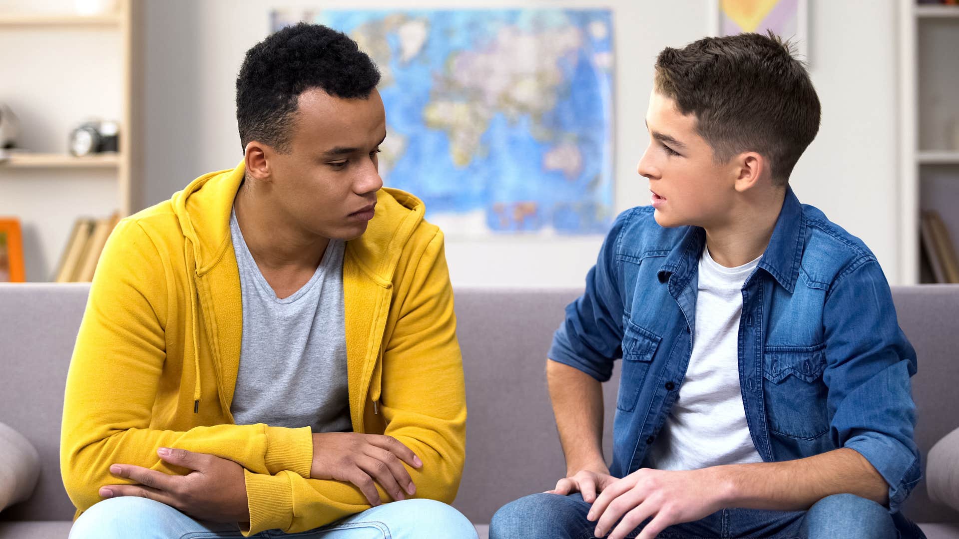 Two young men having a serious discussion together.