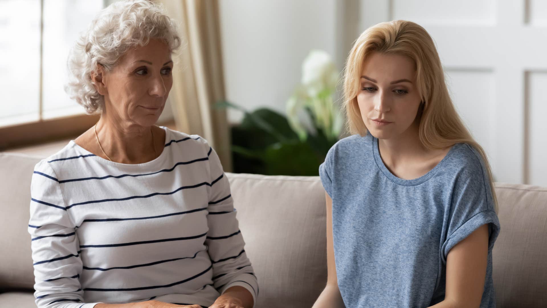 Older woman looking annoyed at her adult daughter.