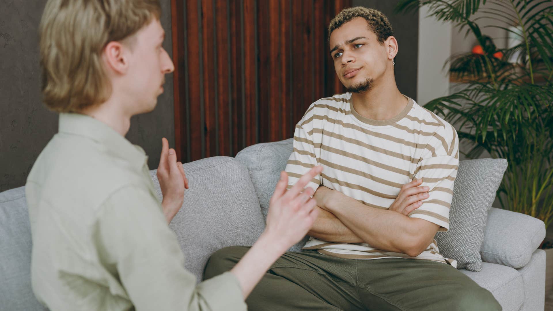 Couple arguing with each other on the couch