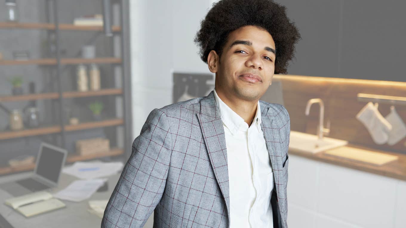 Smug professional man smiling in his office.