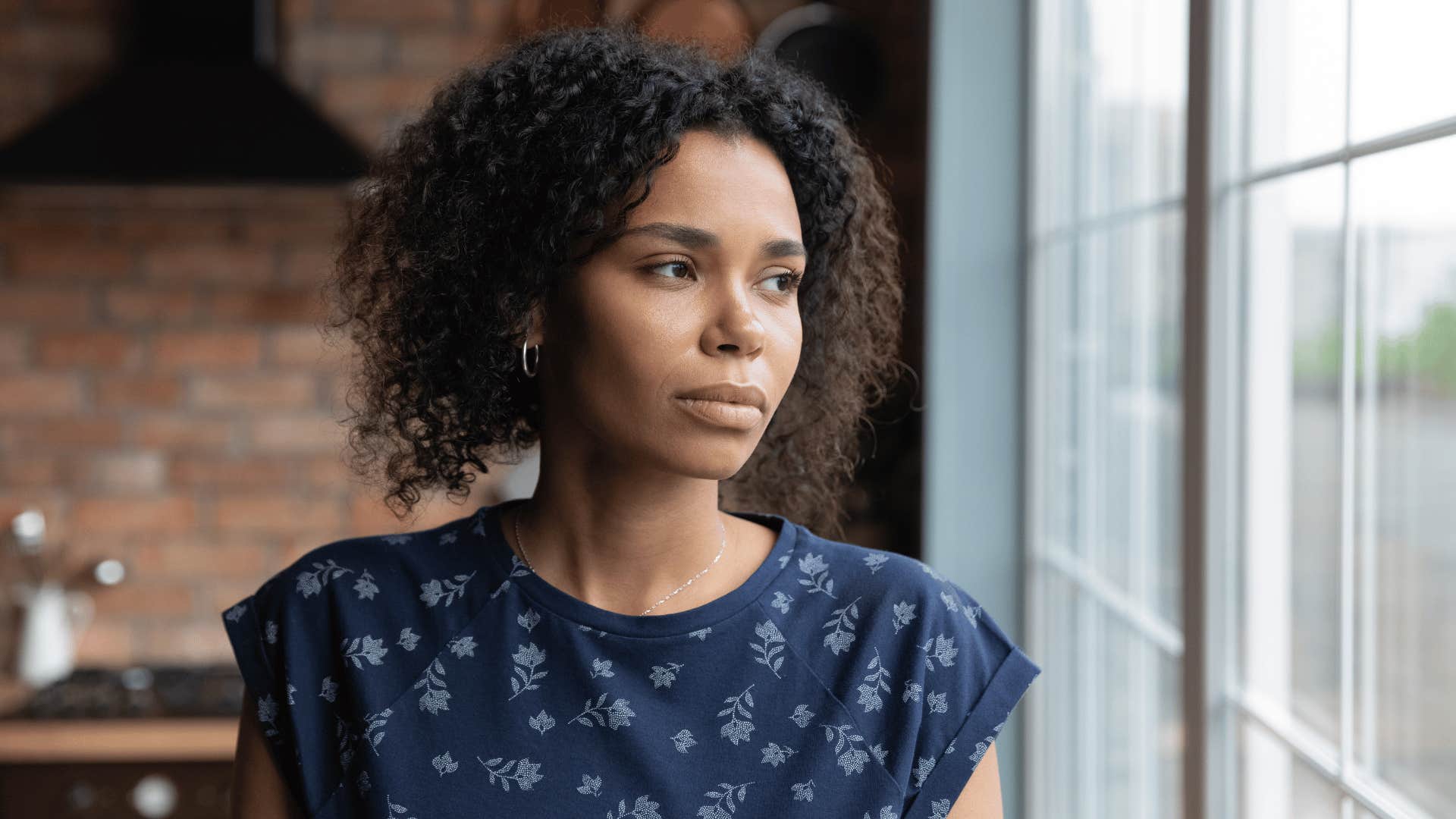 woman looking out window