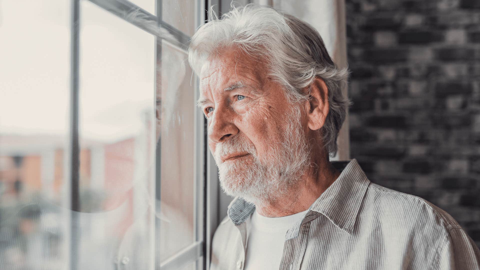 man looking out of window