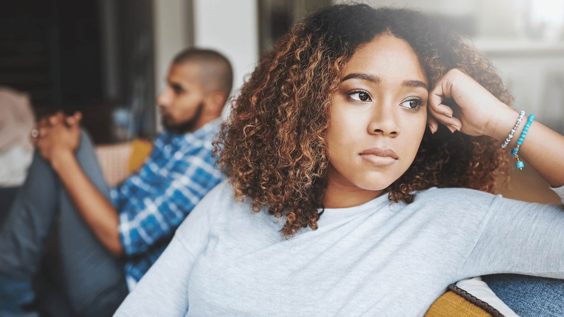 woman looking away from distant partner 