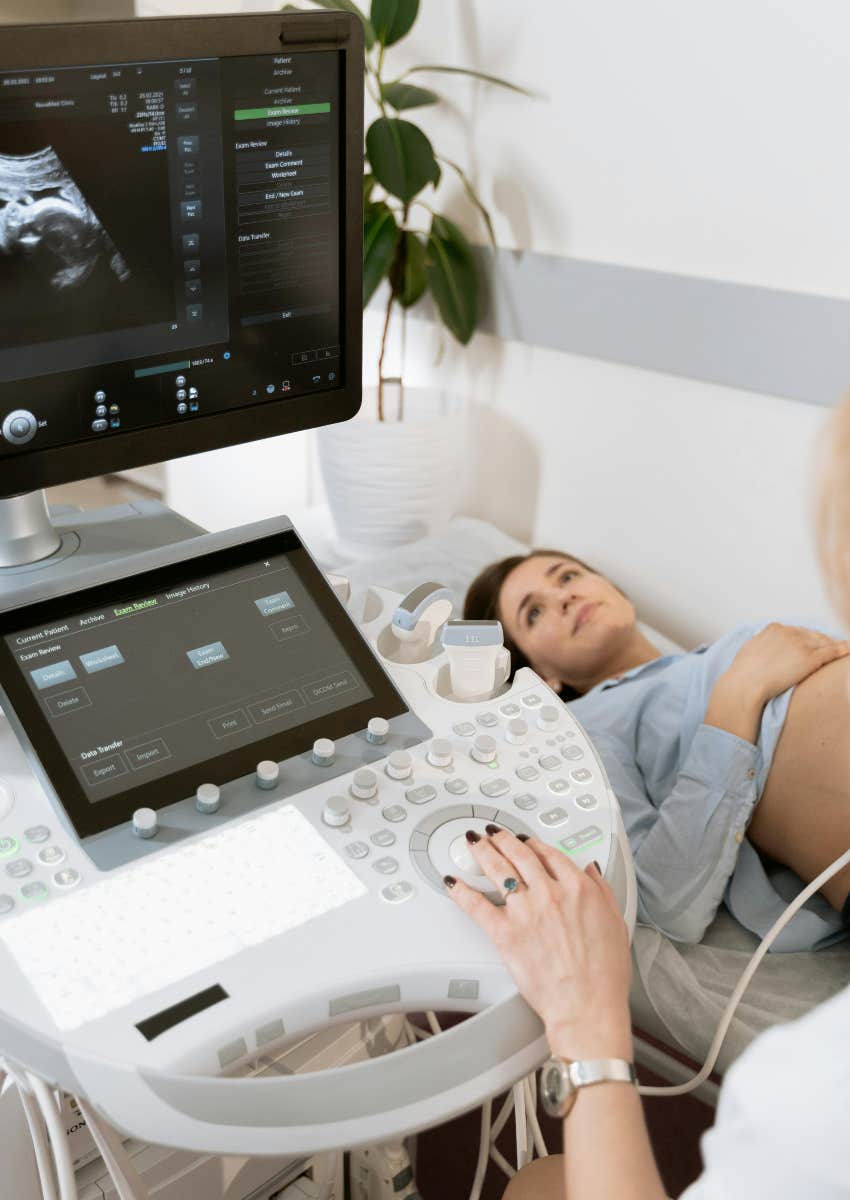 pregnant woman laying on exam table getting an ultrasound