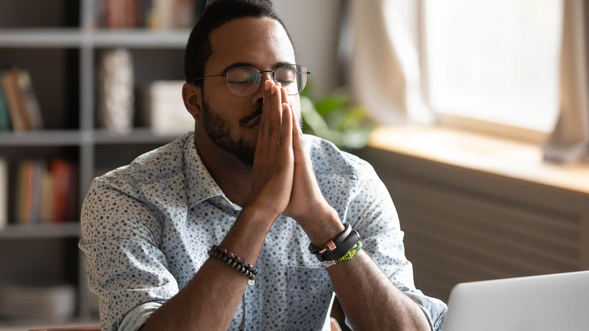 Man looking nervous with his eyes closed.