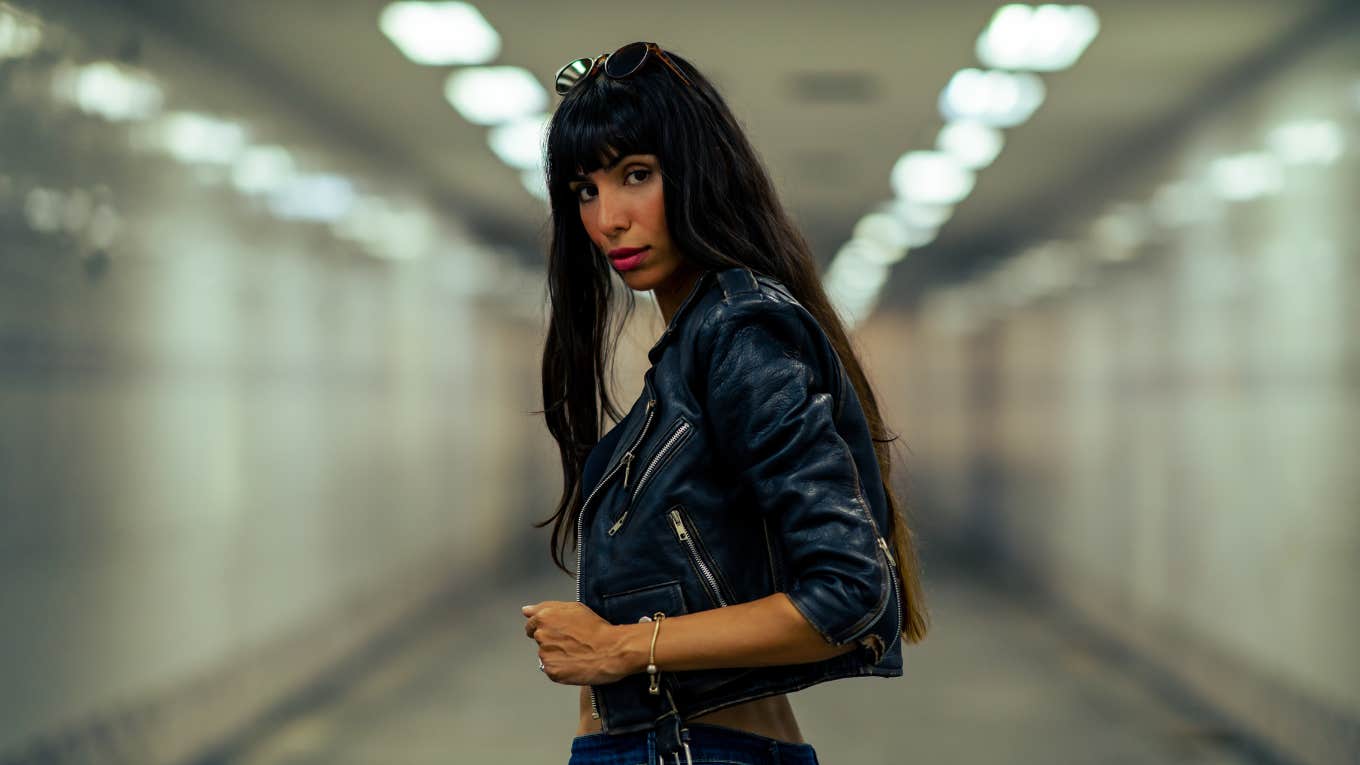 Portrait of Fashionable woman in stylish clothing walking down cross street tunnel