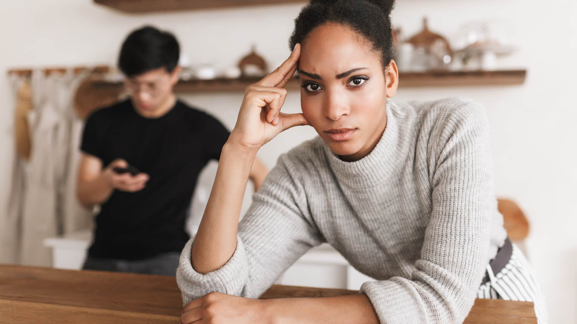 Woman looking annoyed next to a man