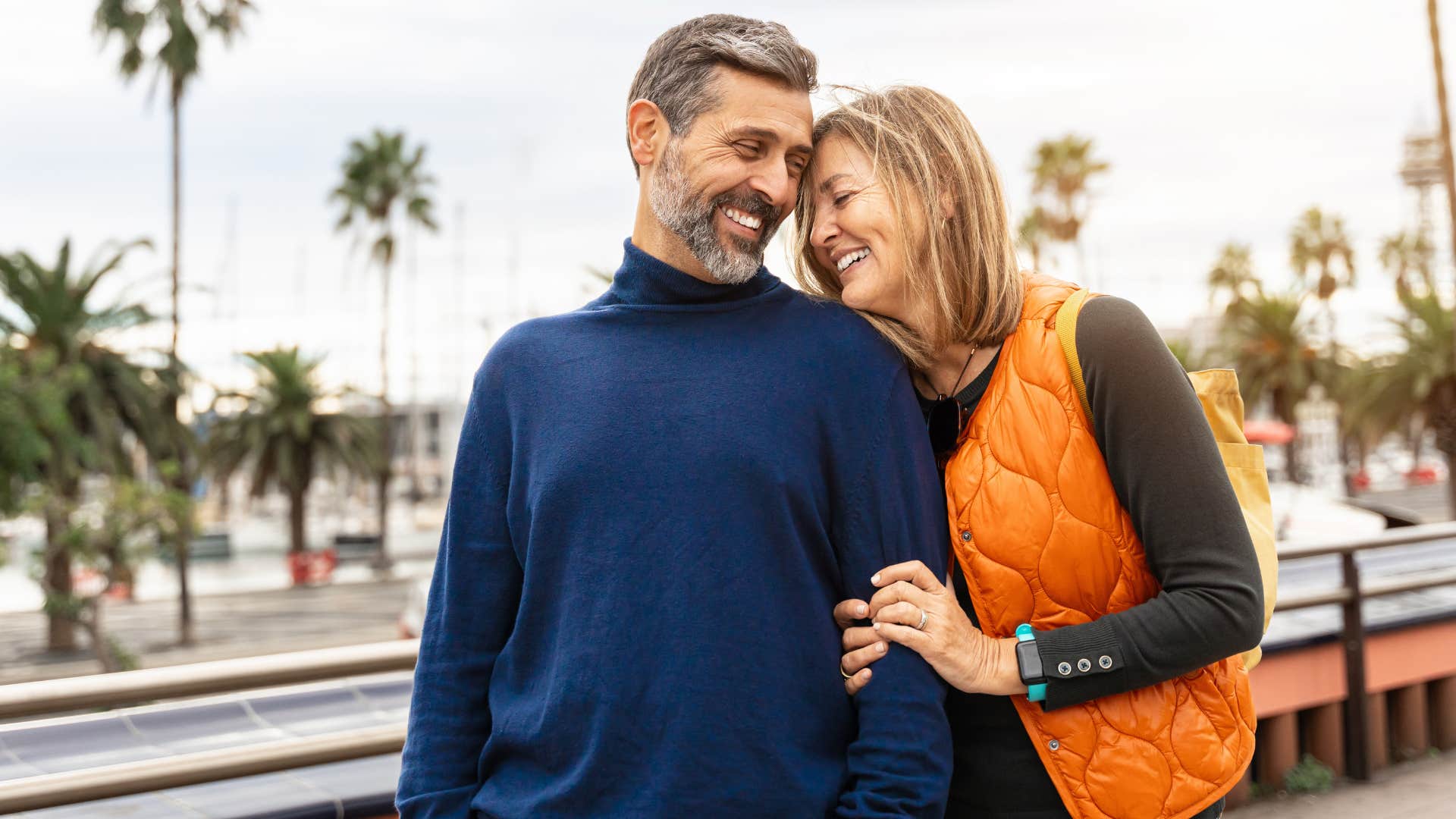 Man hugging a woman outside.