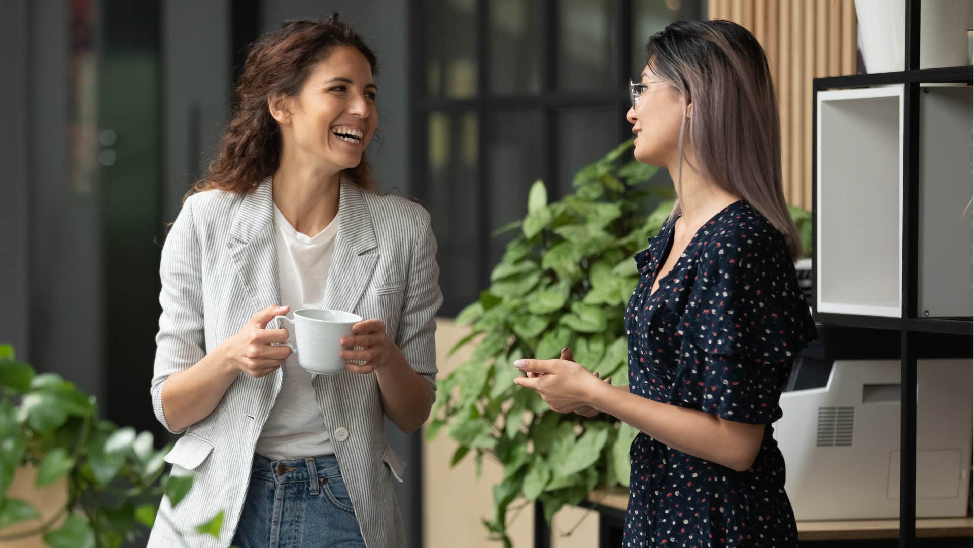 Two women smiling and talking to each other.