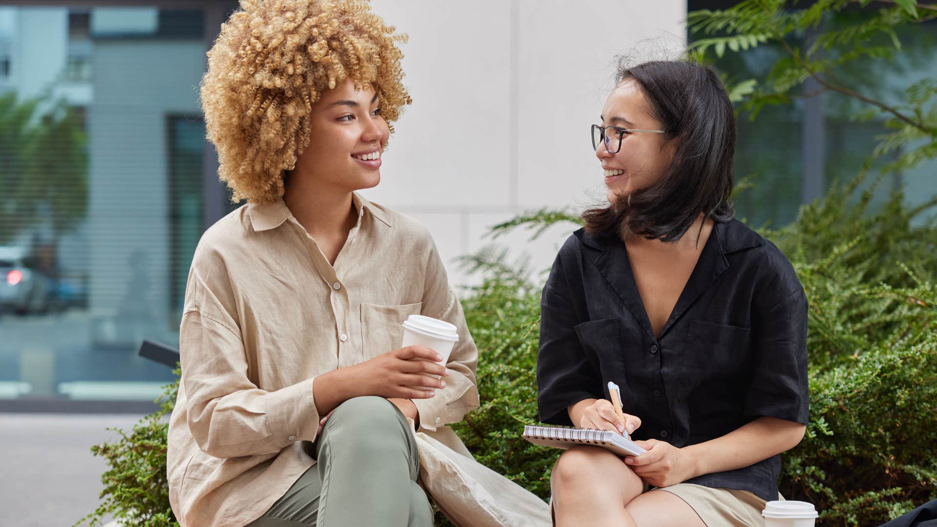 Two women smiling and talking to each other.