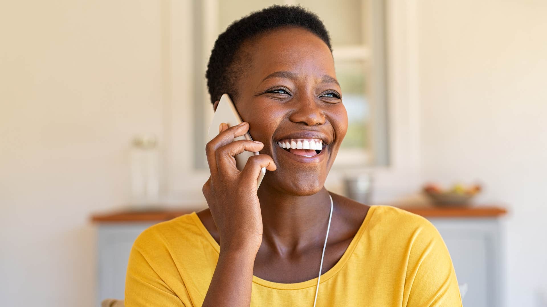 Woman smiling while talking on the phone.