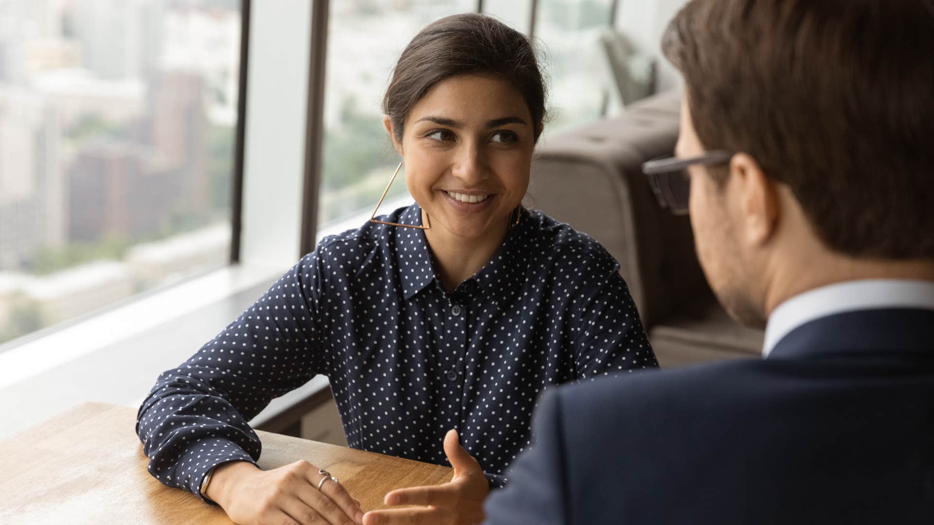 Professional woman smiling at a male co-worker.