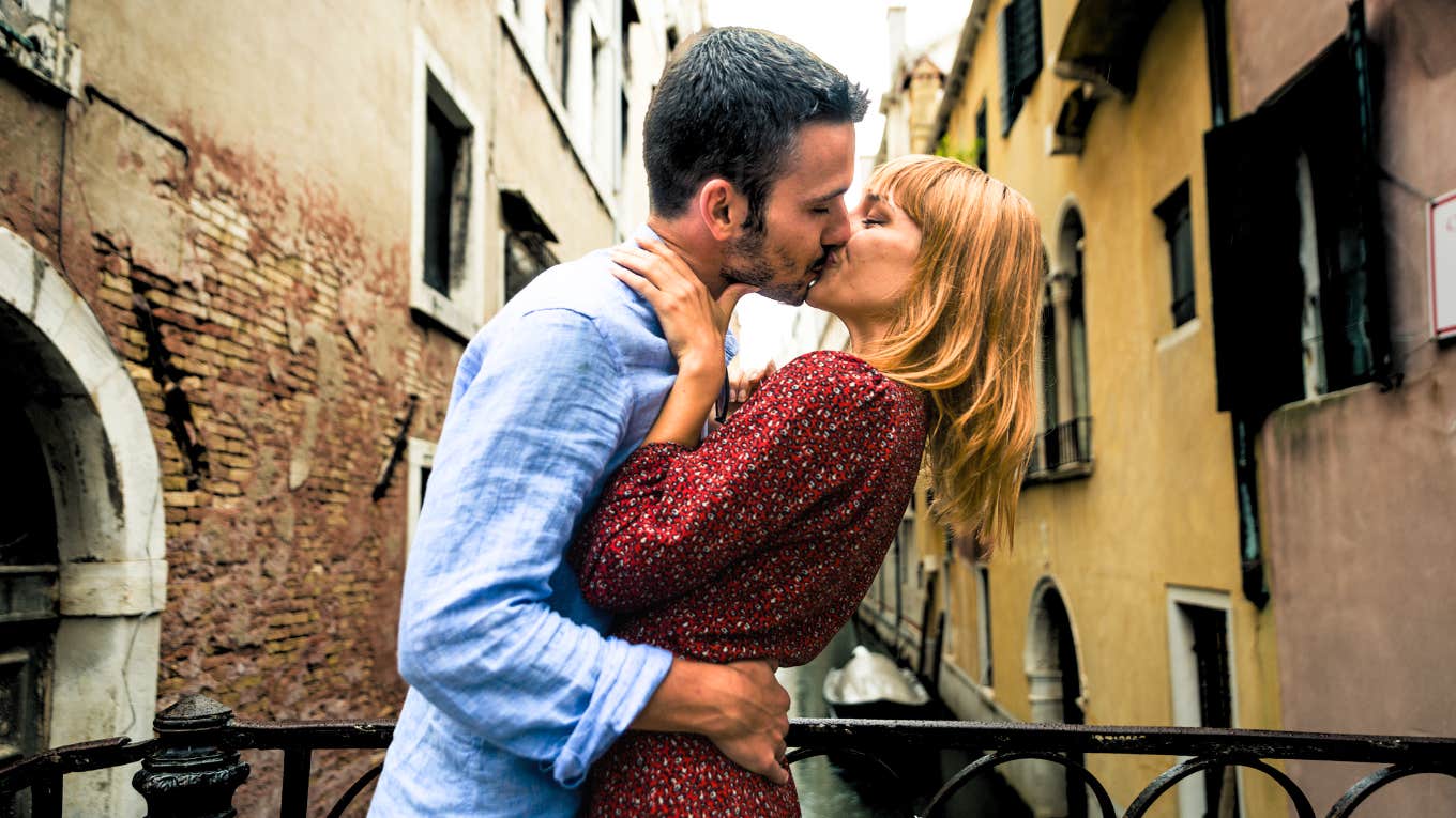 Couple kissing while on a romantic destination vacation.