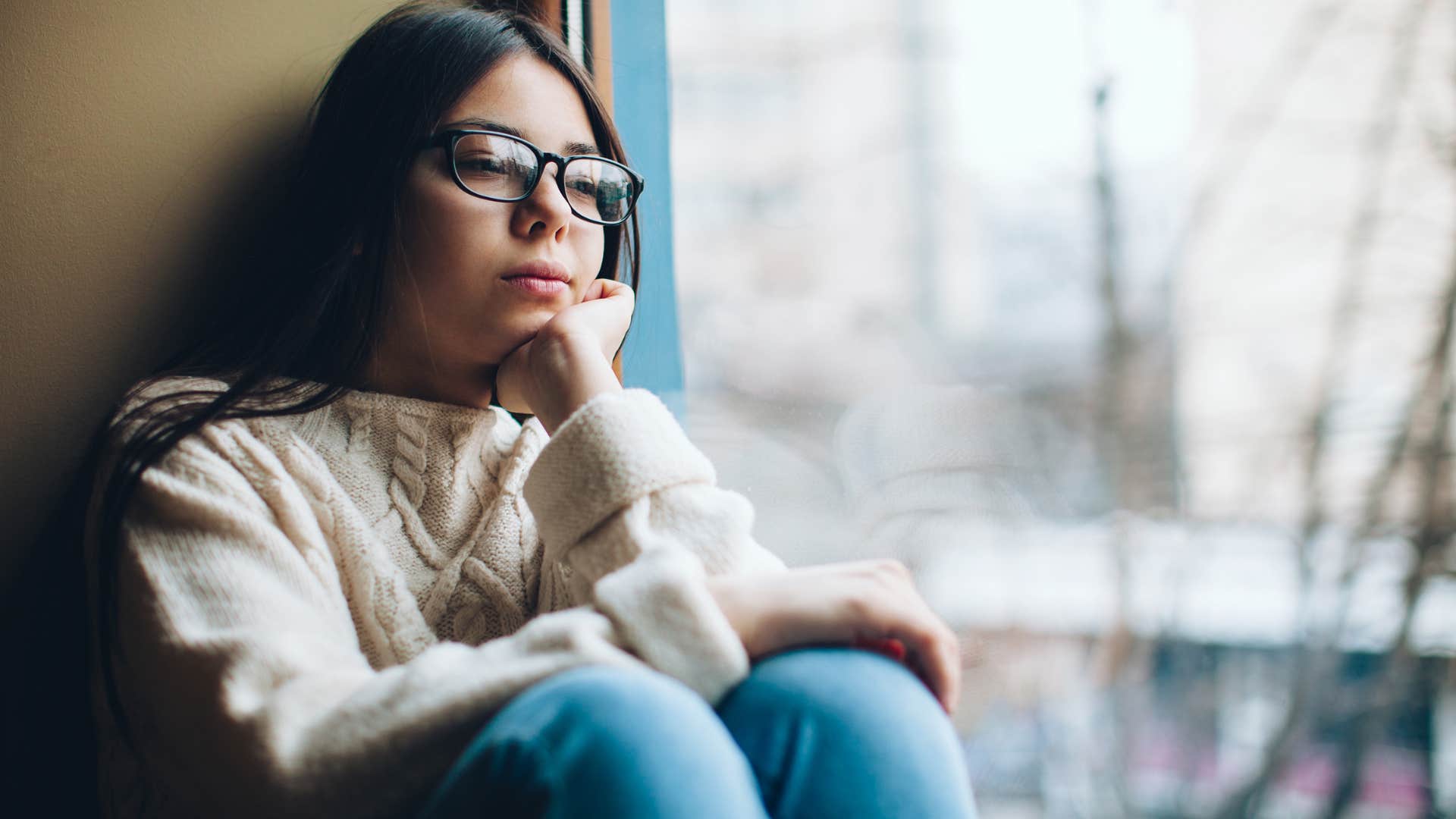 Teenager girl looking sad sitting alone. 