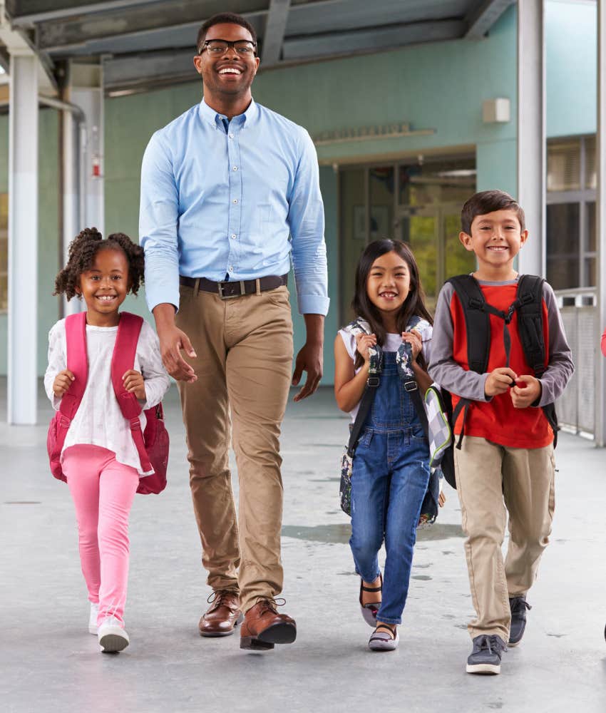 school staff member walking with kids