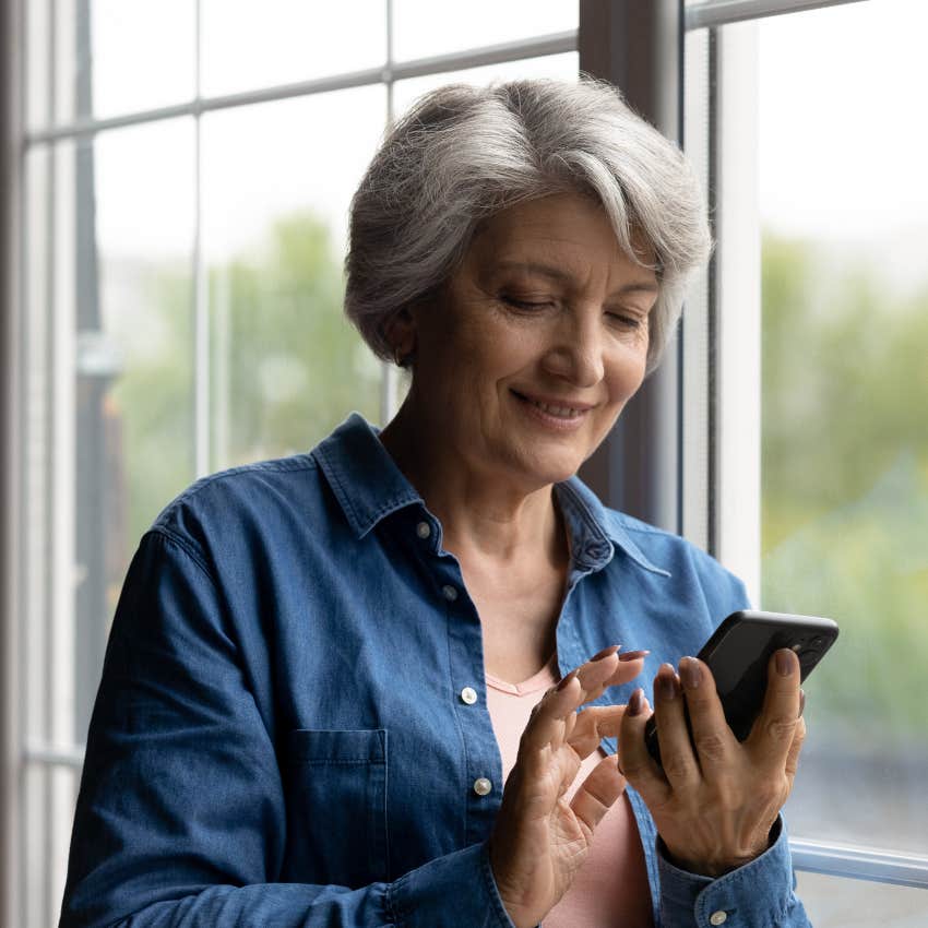 Senior woman texting on her cell phone with the sound on