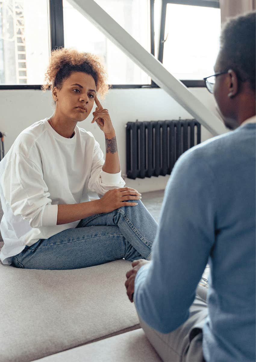 serious woman listening to a man speak