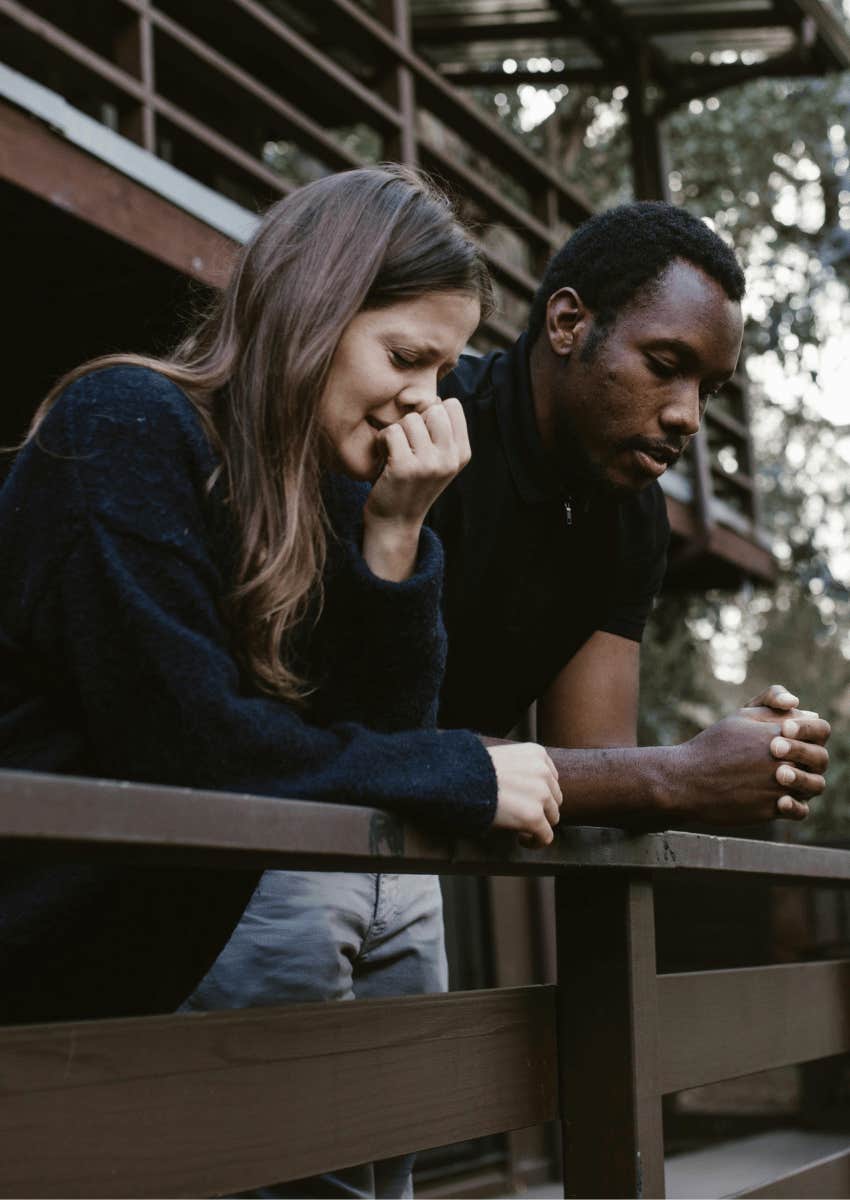 serious young couple standing outdoors