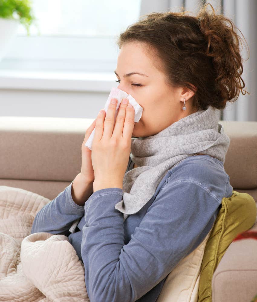 woman with a cold blowing her nose