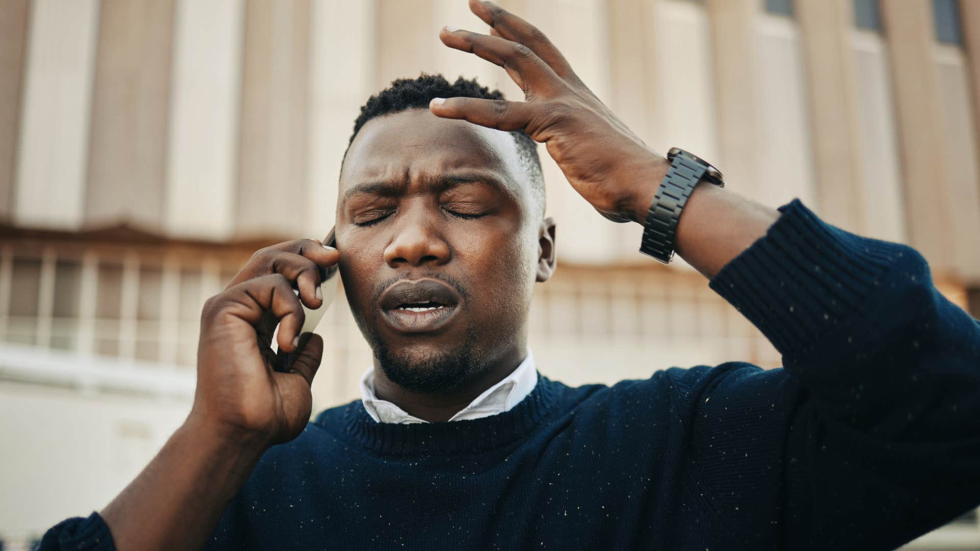 Man looking annoyed talking on his cell phone. 