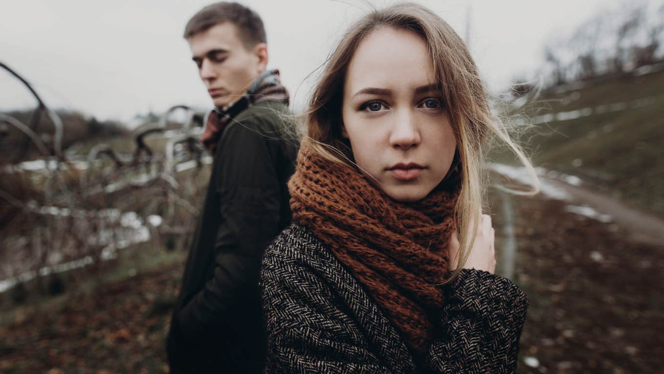 stylish hipster couple posing in windy autumn park