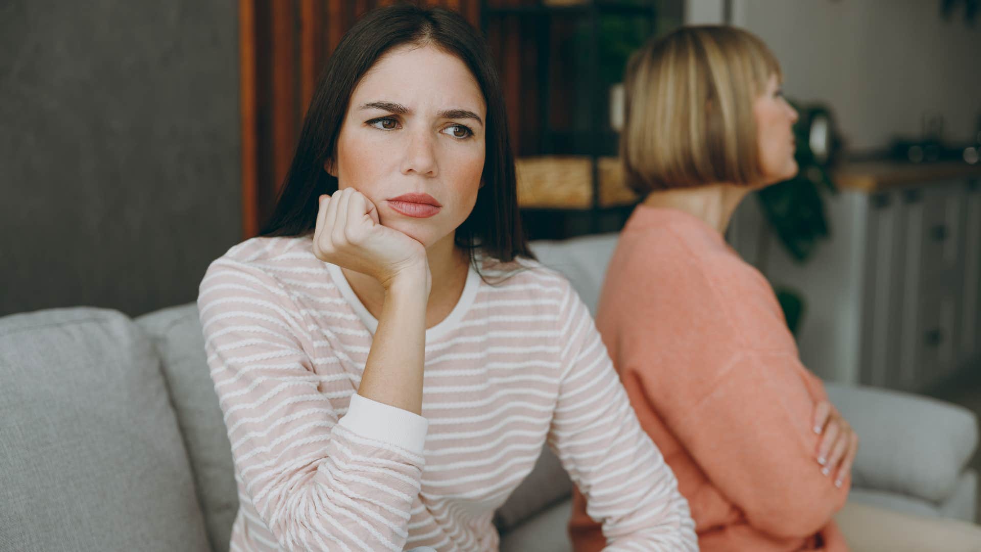 Woman looking annoyed turned away from her mother.