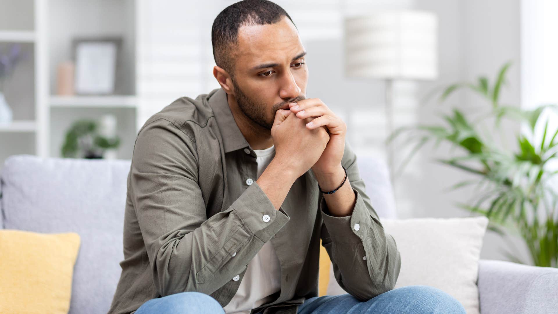 Man looking frustrated on his couch.