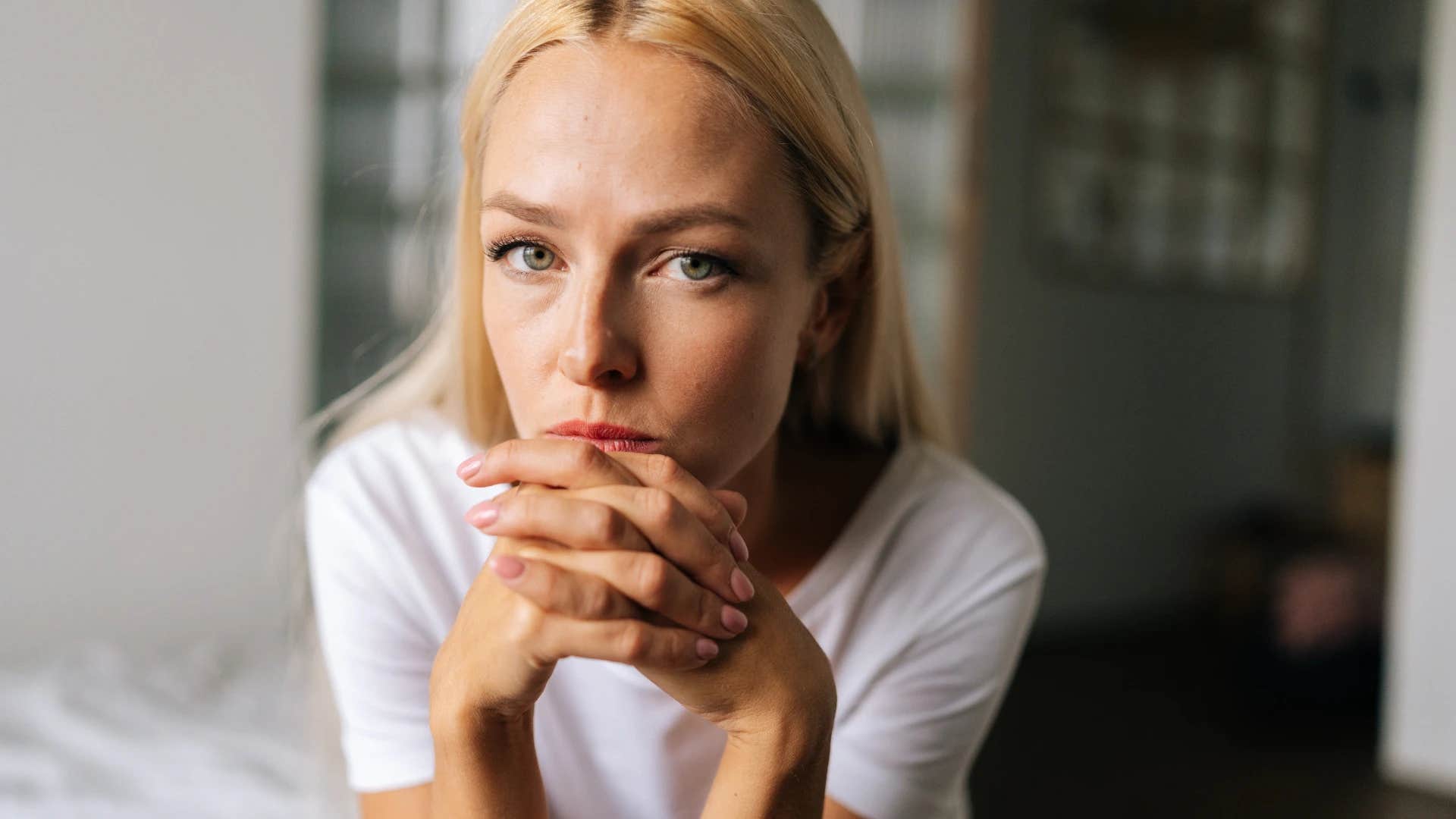 Woman holding her chin in her hands staring at the camera