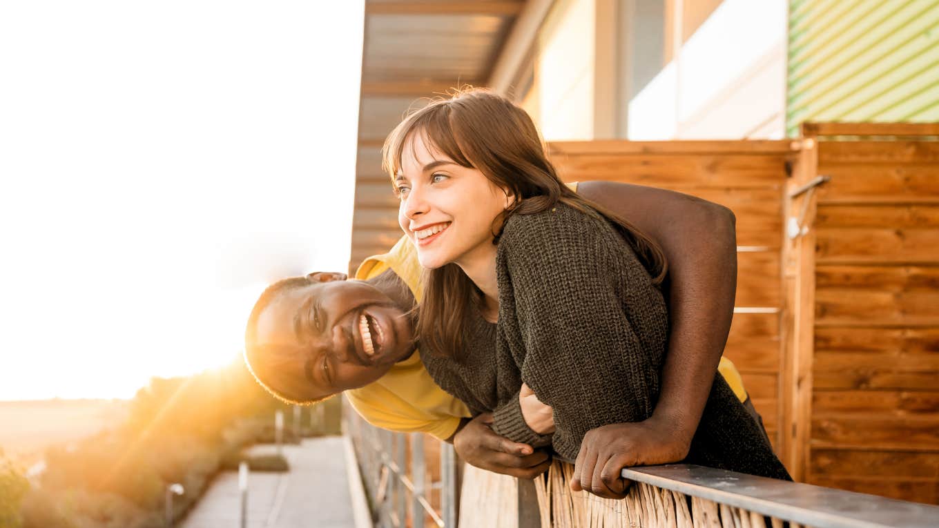 Happy couple on balcony.