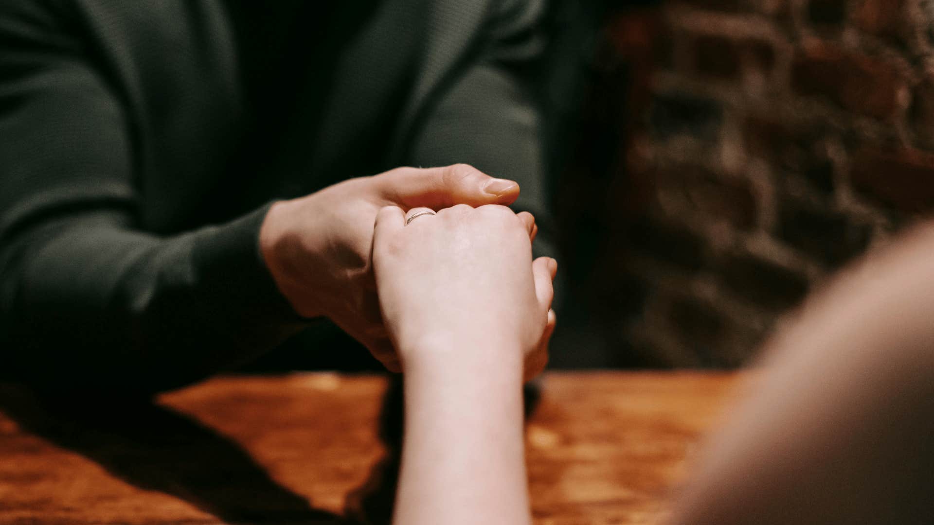 man holding woman's hand