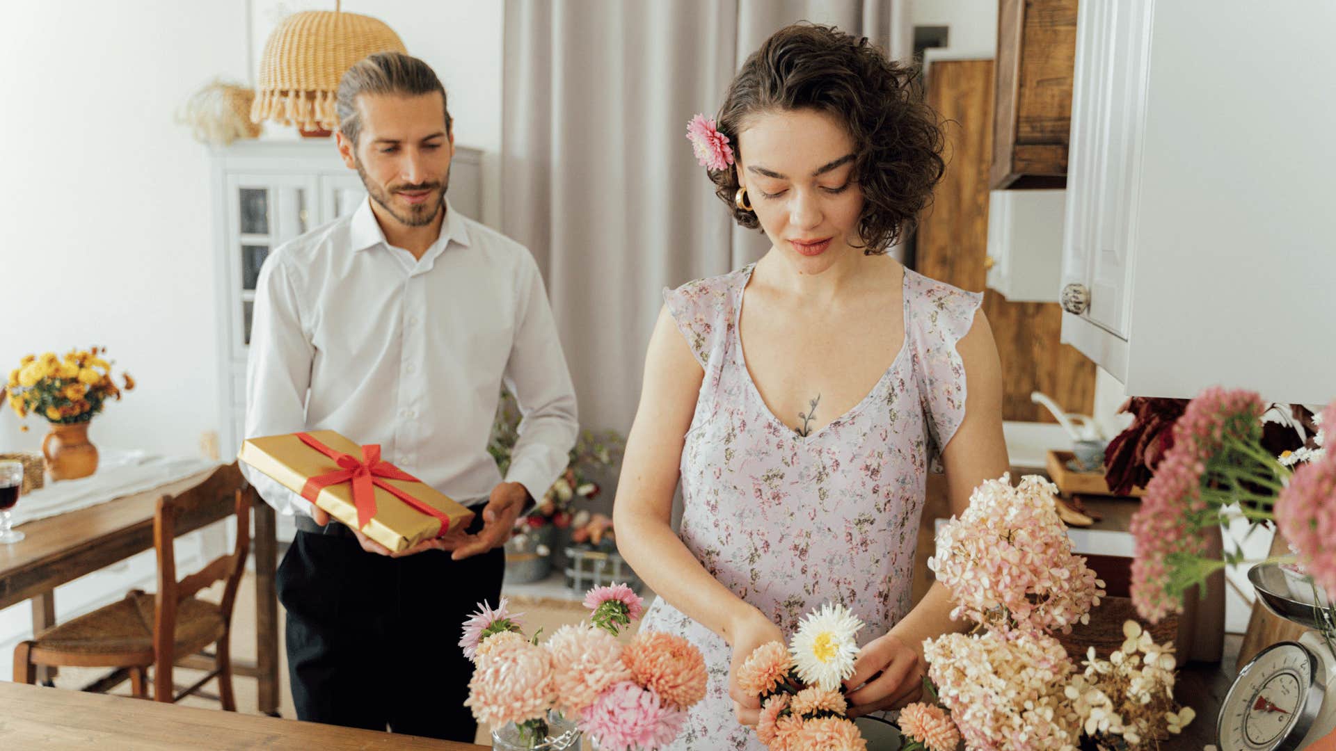 man about to give a gift to a woman