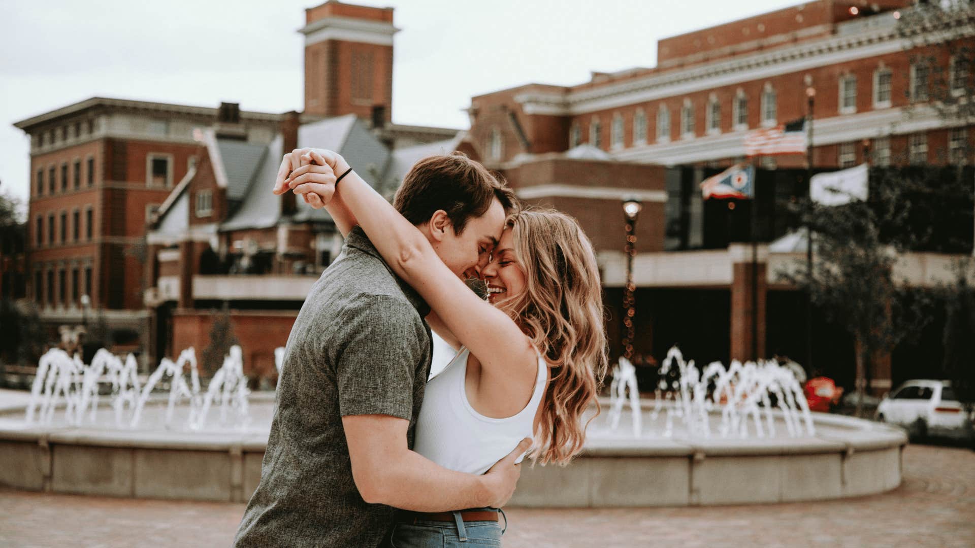 couple embracing in front of fountain