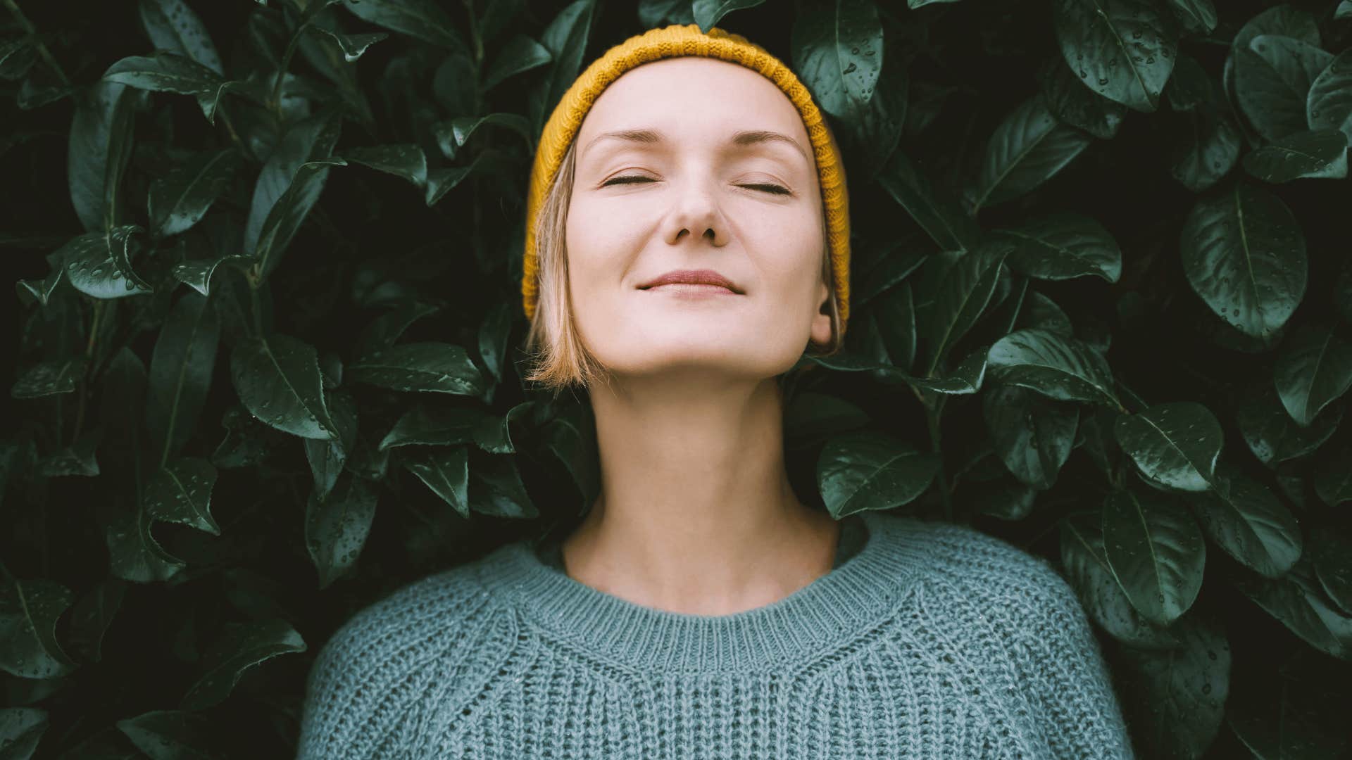 woman closing eyes and smiling