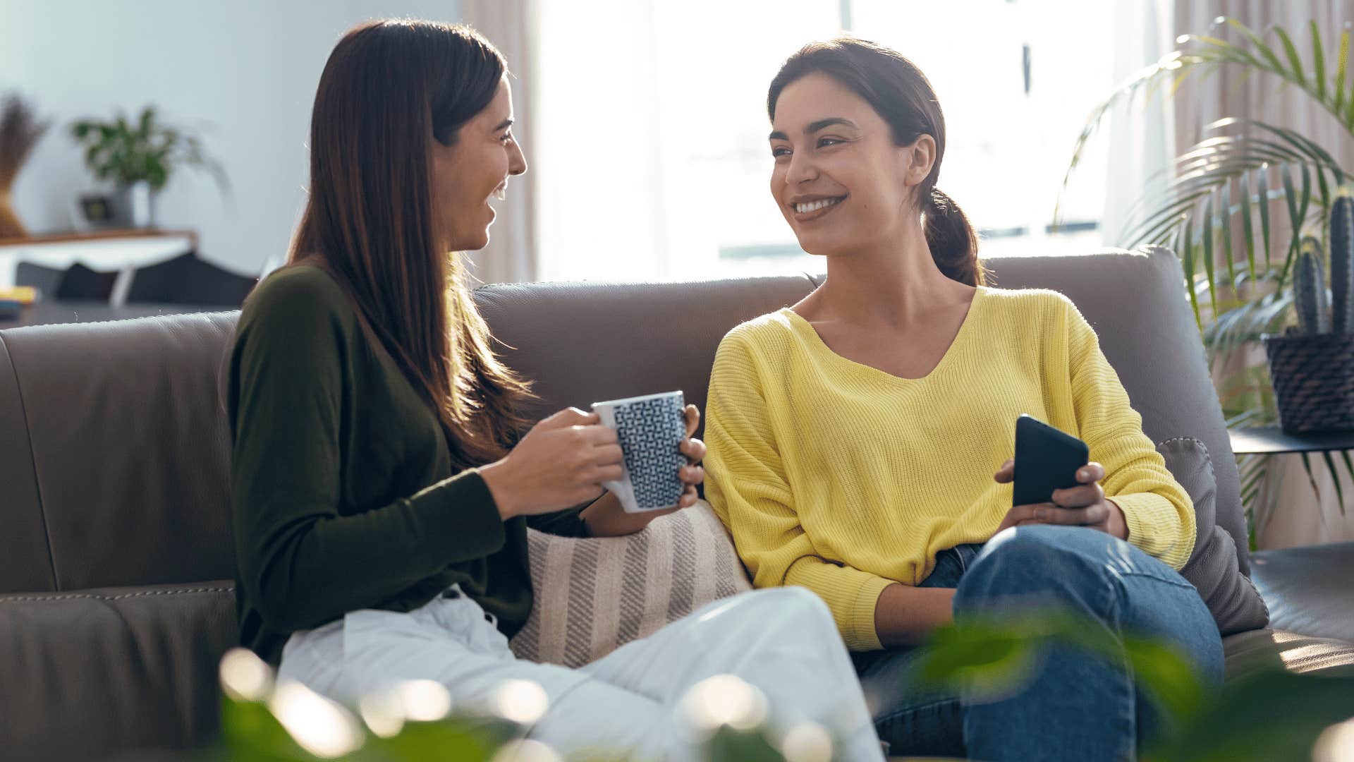 two friends chatting while drinking coffee