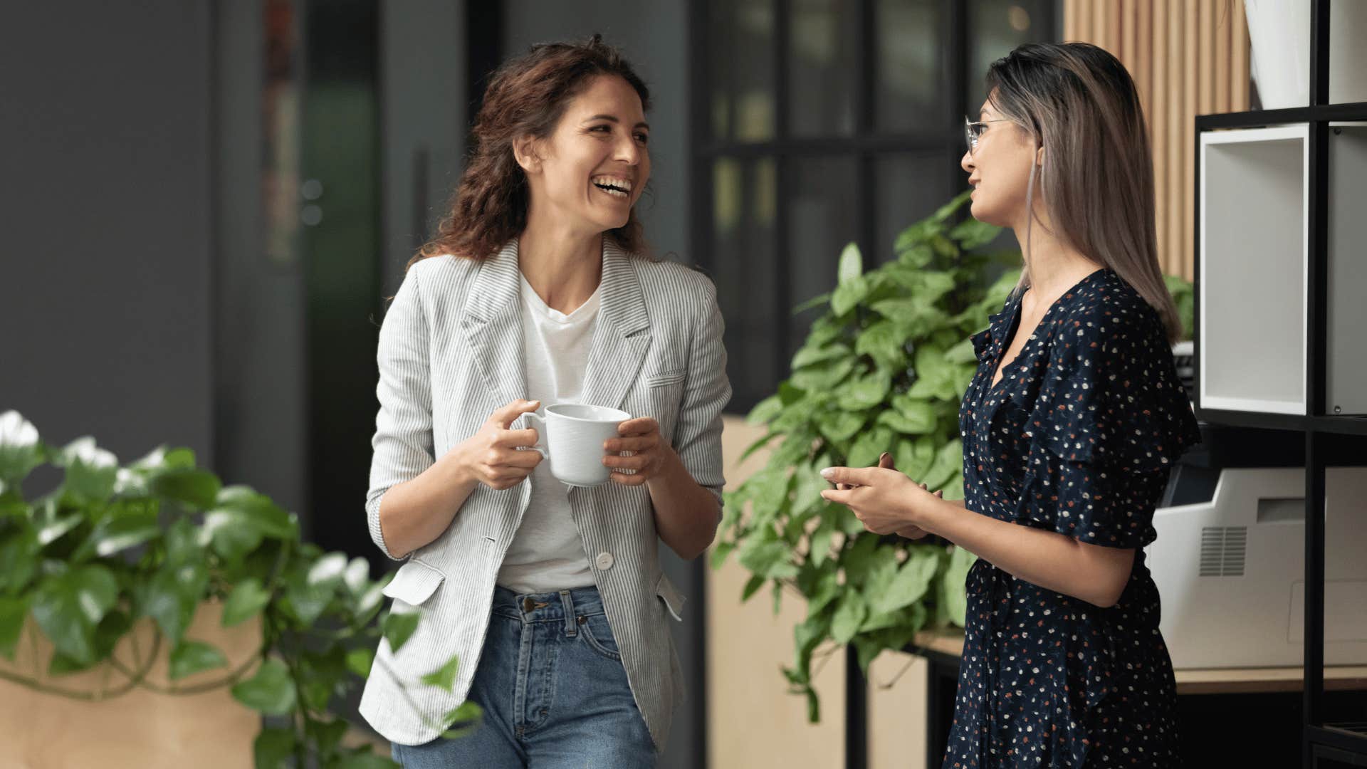 two coworkers discussing something while walking 