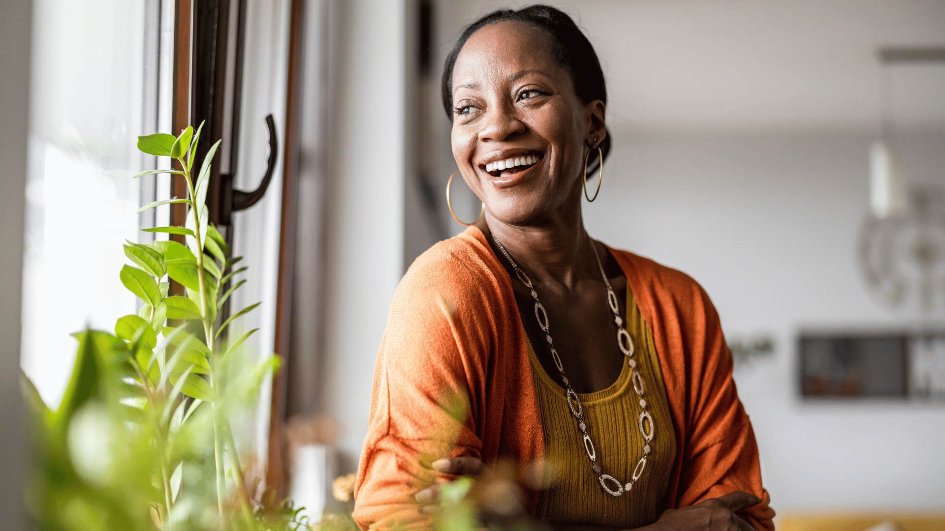 woman looking out of the window smiling 